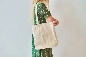 A Girl is holding blank cotton eco tote bag, design mockup.