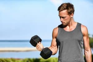 Bicep curl free weights training fitness man outside working out