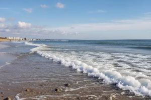 Coastal landscape illustrating the effects of rising sea levels with submerged beach and distant town